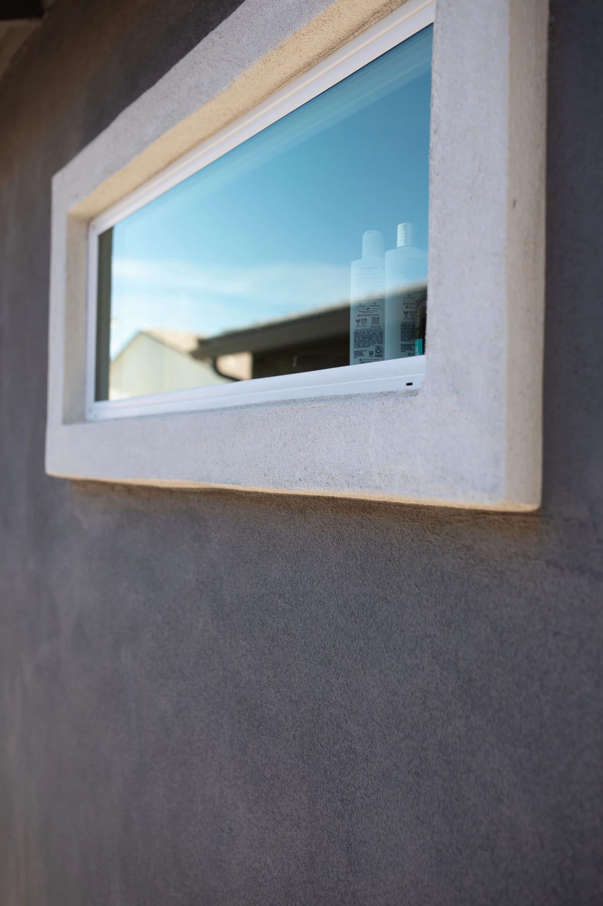 Clean window reflecting a rooftop and blue sky, East Valley, AZ